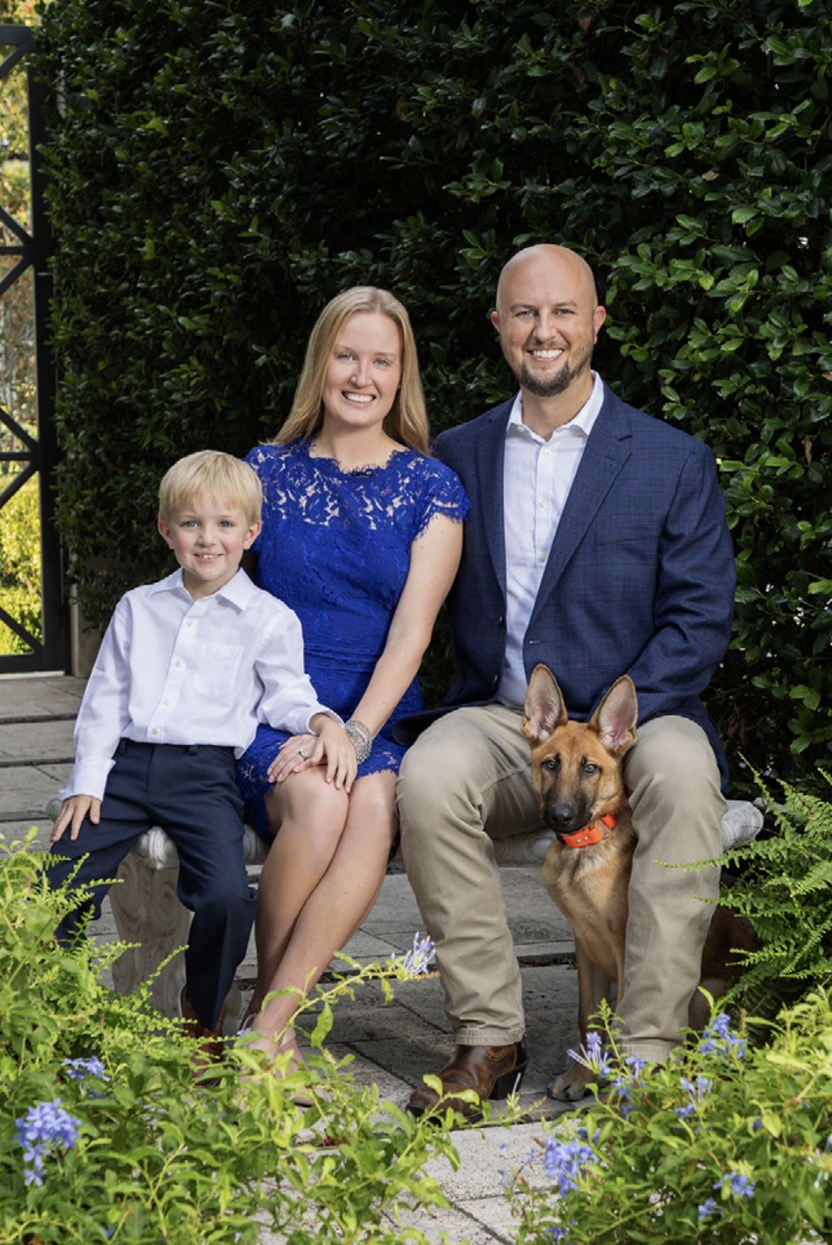 Janie with her husband, their son, and their Belgian Malinois
